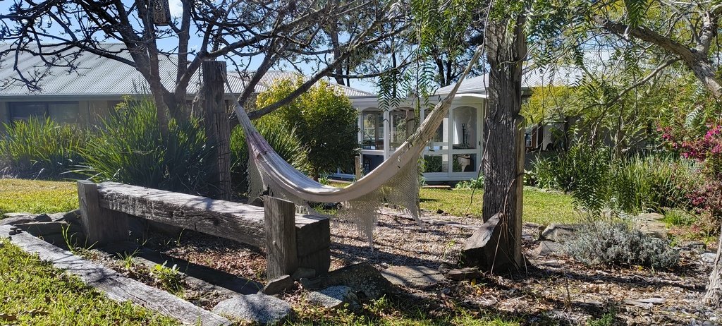 A photograph of a cloth hammock in the garden in front of Murrah Dream Retreat