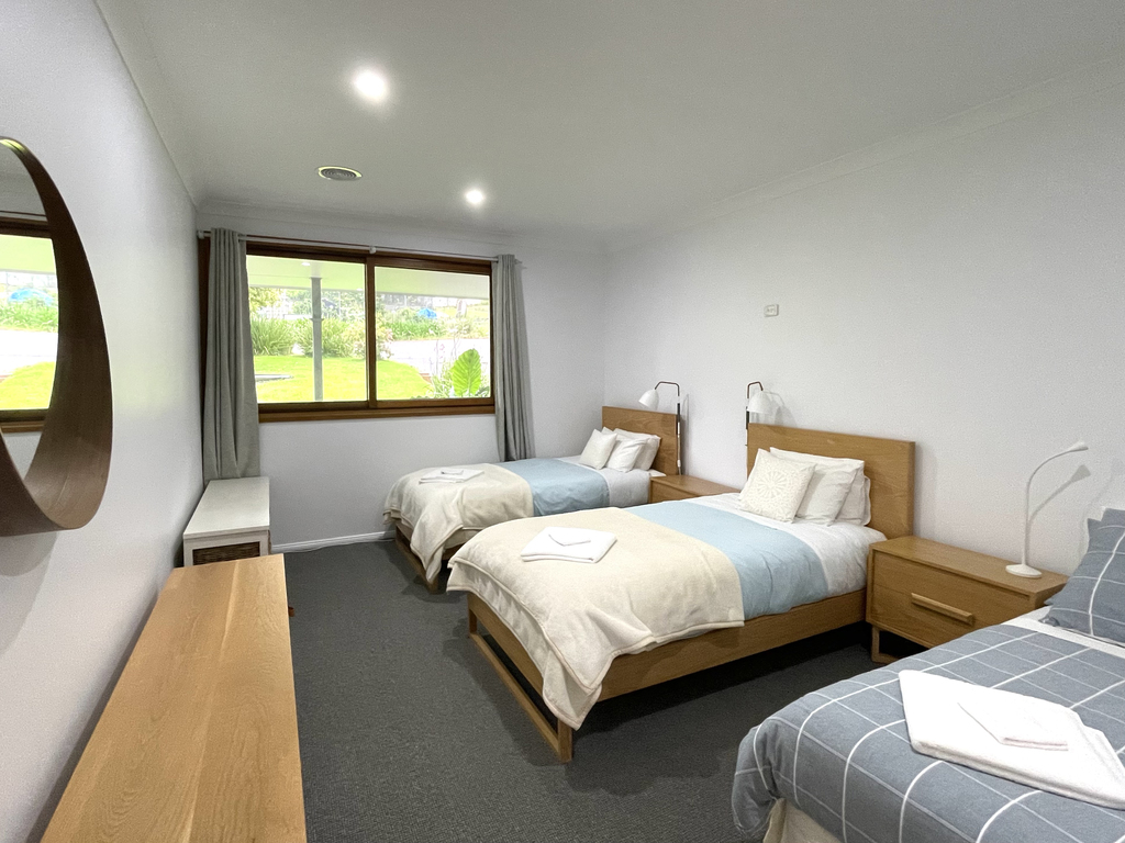 A photograph of the Triple Share Room with two twin King Single beds and one Double Bed