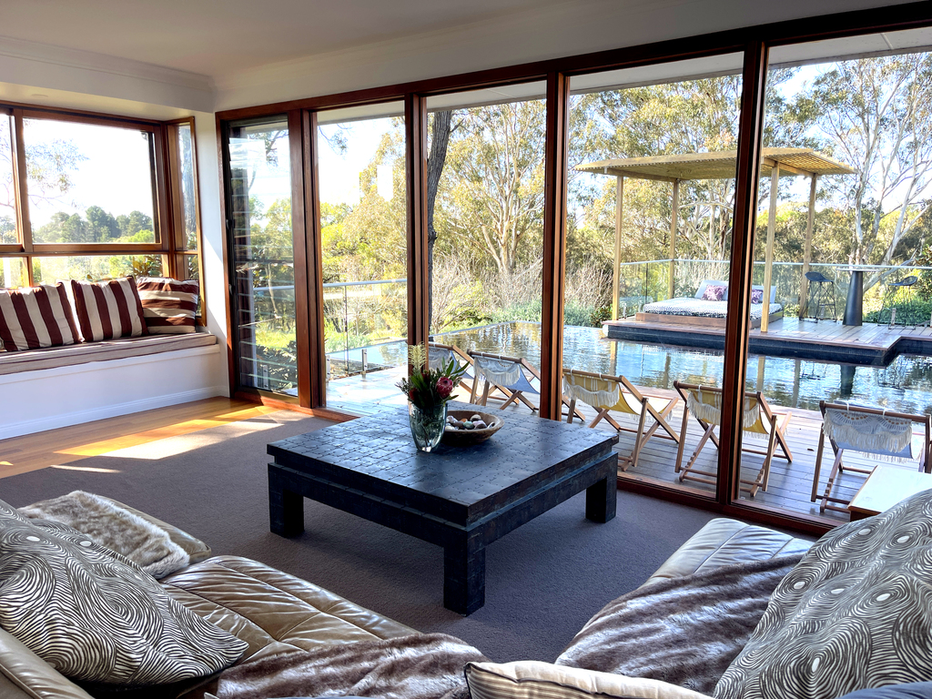 A photograph of the lounge area at Murrah Dream Retreat, with adjacent infinity pool